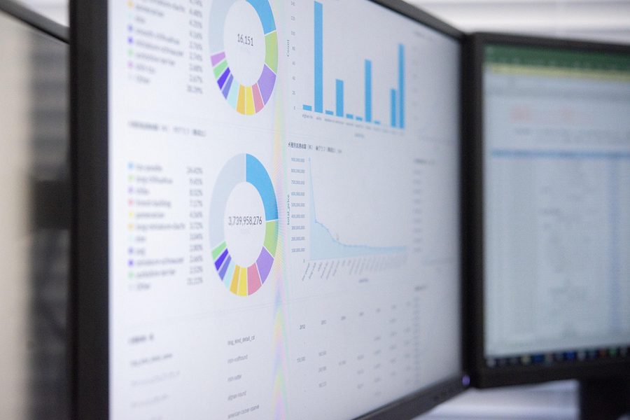 Two monitors showing engineering dashboards